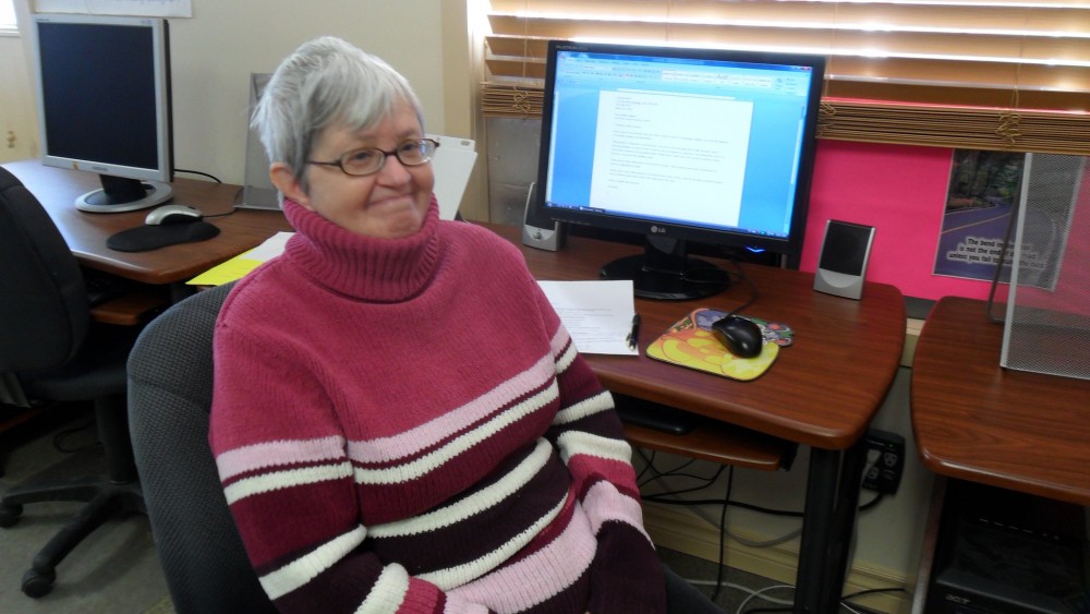 Caroline's sits at the computer desk